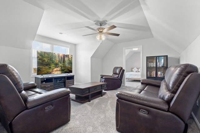 living room featuring lofted ceiling, light colored carpet, ceiling fan, and visible vents