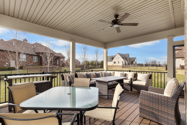 wooden deck featuring outdoor dining area, a fenced backyard, an outdoor hangout area, a ceiling fan, and a residential view