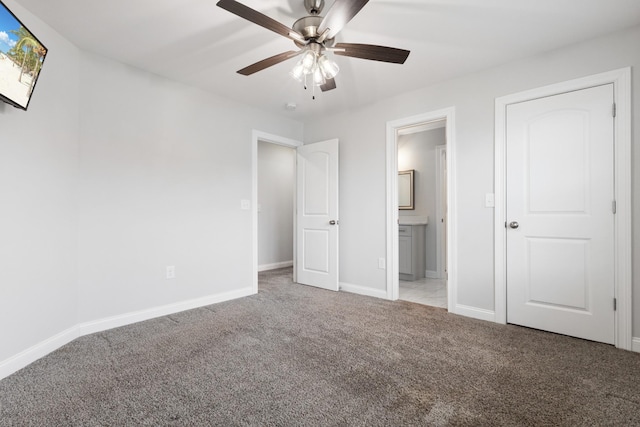 unfurnished bedroom featuring ensuite bath, baseboards, ceiling fan, and light colored carpet