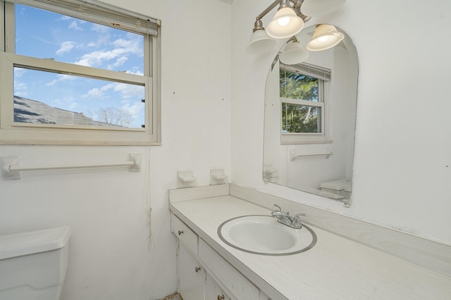 bathroom featuring toilet and vanity