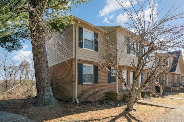 view of side of property featuring brick siding