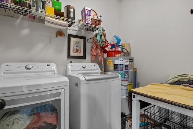 laundry area with laundry area, separate washer and dryer, and electric water heater