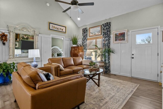 living room with high vaulted ceiling, wood finished floors, and a ceiling fan