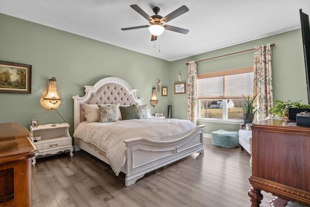 bedroom with ceiling fan and wood finished floors