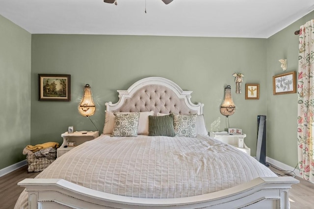 bedroom featuring wood finished floors, a ceiling fan, and baseboards