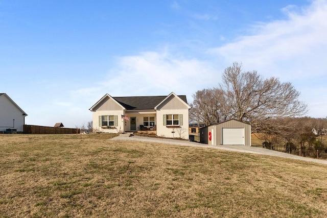 view of front of property with driveway, a detached garage, a front lawn, and an outdoor structure