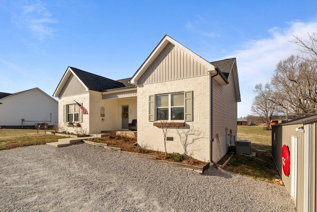 view of front of property featuring board and batten siding and cooling unit