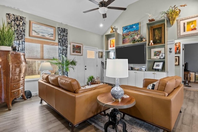 living room with lofted ceiling, a ceiling fan, and wood finished floors