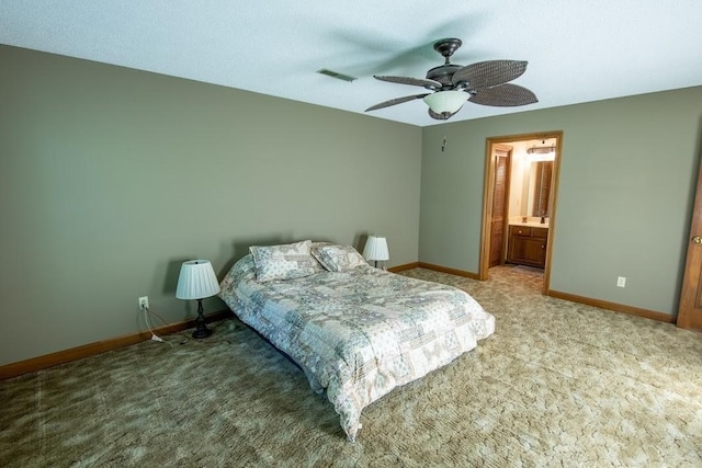 carpeted bedroom with baseboards, visible vents, a ceiling fan, and ensuite bathroom