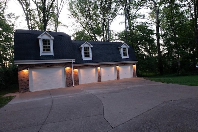 view of front facade with brick siding and roof with shingles