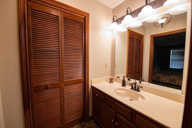 bathroom with a closet and vanity