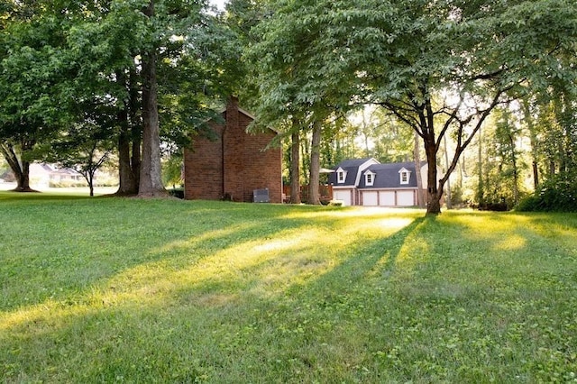 view of yard with driveway and an attached garage