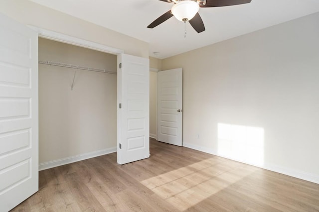 unfurnished bedroom with a ceiling fan, a closet, baseboards, and wood finished floors