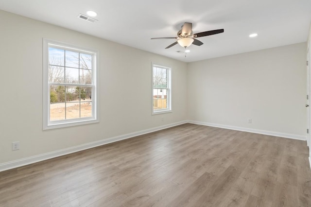 unfurnished room featuring recessed lighting, visible vents, a ceiling fan, wood finished floors, and baseboards