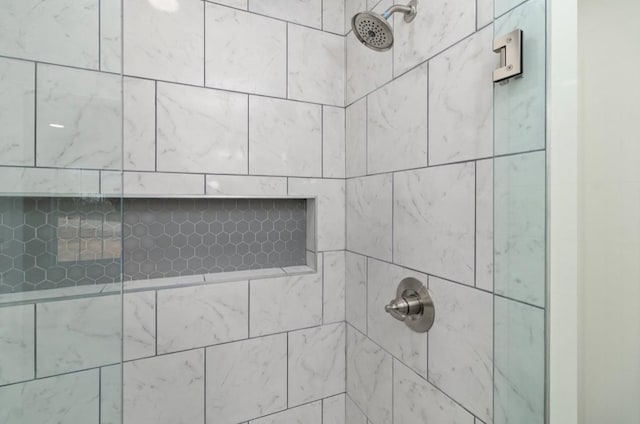 interior details featuring tiled shower