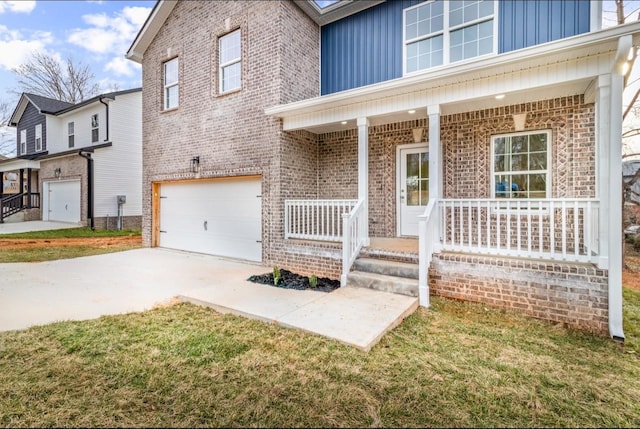 view of front of home with an attached garage, covered porch, board and batten siding, and brick siding