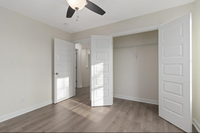 unfurnished bedroom with a ceiling fan, a closet, baseboards, and wood finished floors