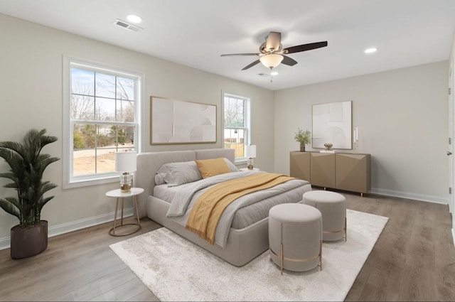 bedroom with recessed lighting, wood finished floors, a ceiling fan, visible vents, and baseboards