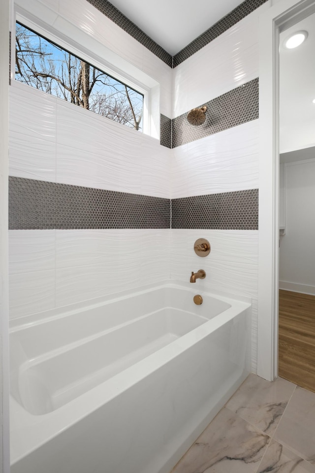 full bathroom featuring marble finish floor, walk in shower, and a bathing tub