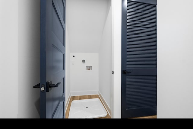 interior space featuring laundry area, washer hookup, wood finished floors, and baseboards