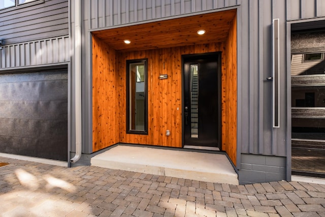 entrance to property featuring a garage and board and batten siding