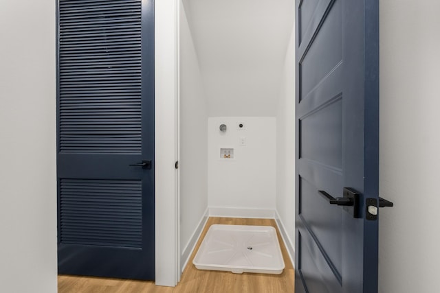 washroom with washer hookup, laundry area, baseboards, and light wood finished floors