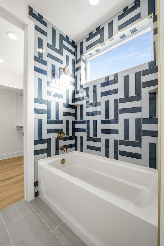 full bathroom with a tub and tile patterned floors