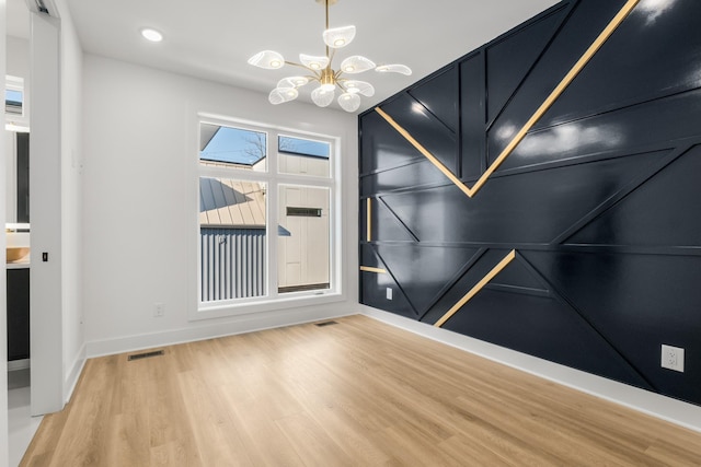 unfurnished room with visible vents, baseboards, light wood-style floors, a chandelier, and recessed lighting