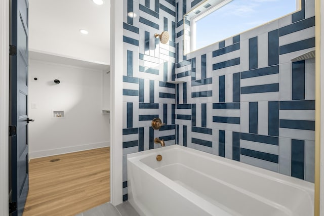 bathroom featuring recessed lighting, wood finished floors, a bath, and baseboards