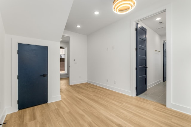 unfurnished room featuring light wood-style floors, baseboards, and recessed lighting