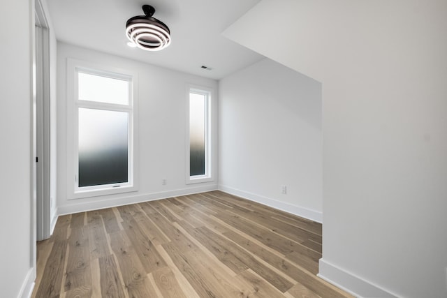 bonus room featuring visible vents, baseboards, and wood finished floors