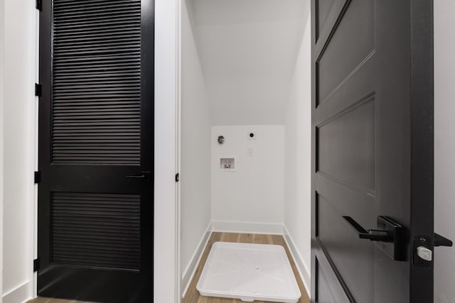 washroom featuring hookup for a washing machine, laundry area, baseboards, and wood finished floors