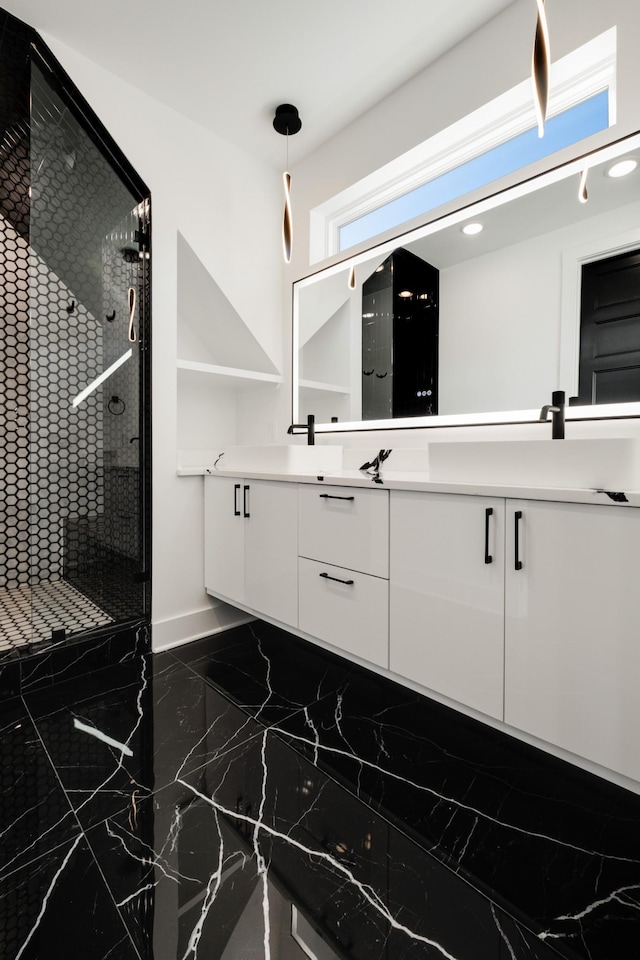 full bathroom featuring marble finish floor, baseboards, tiled shower, and vanity