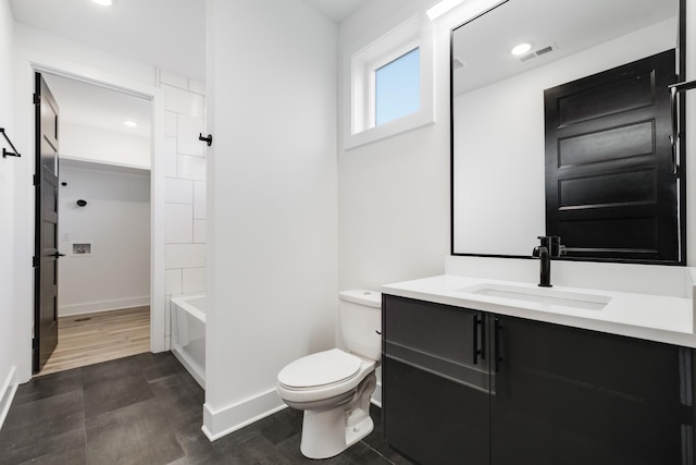 full bathroom with toilet, baseboards, visible vents, and vanity