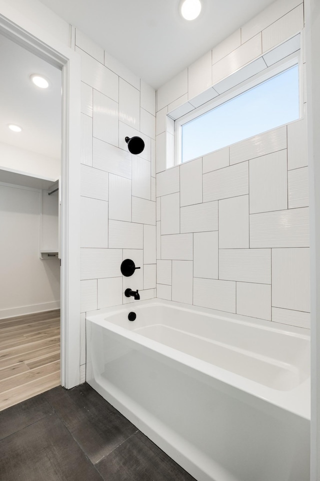 full bath featuring baseboards, shower / bathing tub combination, wood finished floors, and recessed lighting