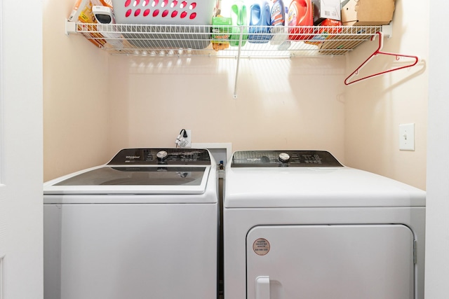 clothes washing area featuring washer and dryer and laundry area