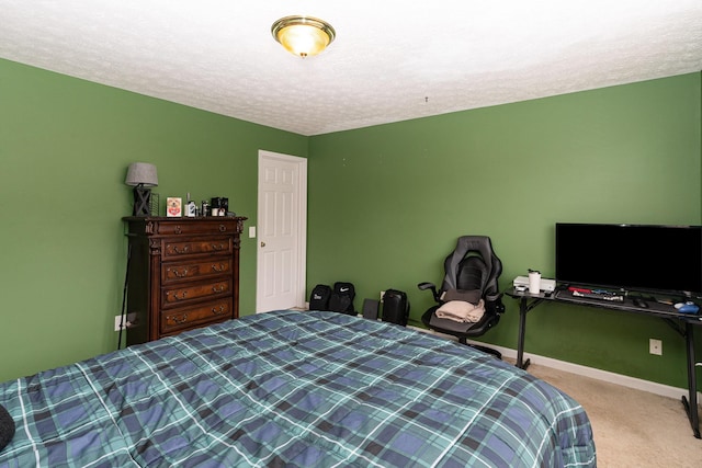 bedroom with a textured ceiling, carpet, and baseboards