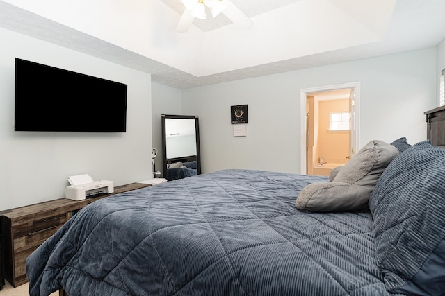 bedroom featuring a ceiling fan and a tray ceiling