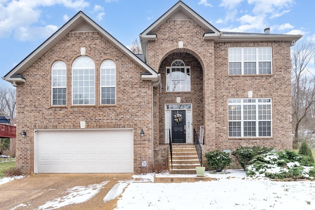 traditional-style house featuring brick siding and an attached garage