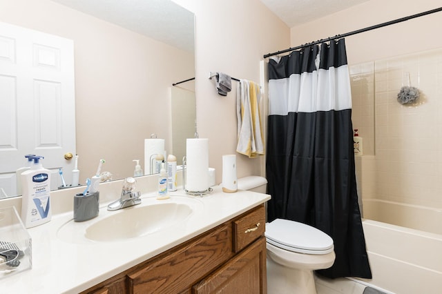 full bath with a textured ceiling, shower / bath combo with shower curtain, vanity, and toilet