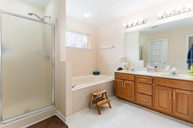 full bathroom with a garden tub, a stall shower, and a sink