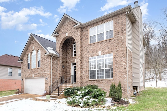 traditional-style home with a garage, a chimney, and brick siding