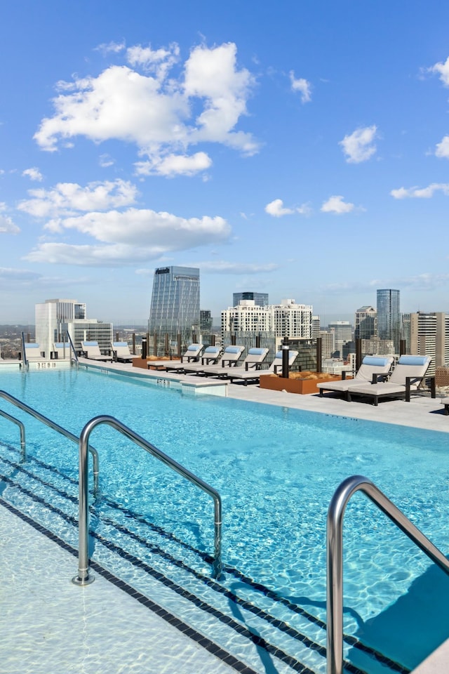 view of swimming pool featuring a city view