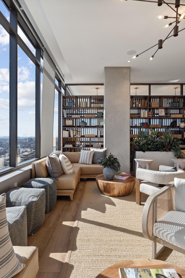 living area with wood finished floors and a chandelier