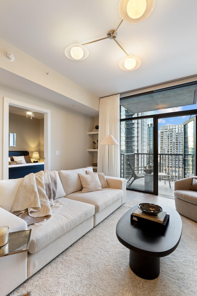 living area featuring a city view, a wall of windows, and a wealth of natural light