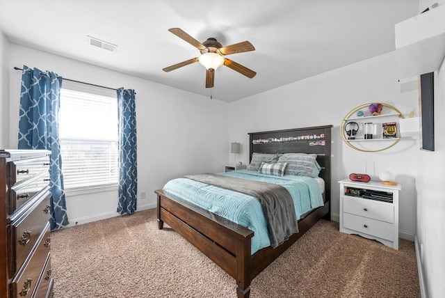 carpeted bedroom with ceiling fan, visible vents, and baseboards