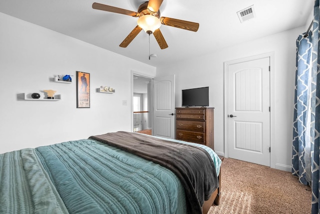 carpeted bedroom with visible vents, ceiling fan, and baseboards