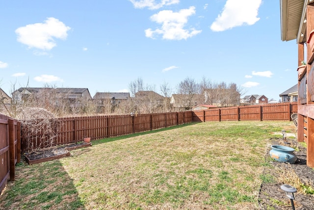 view of yard featuring a fenced backyard and a residential view