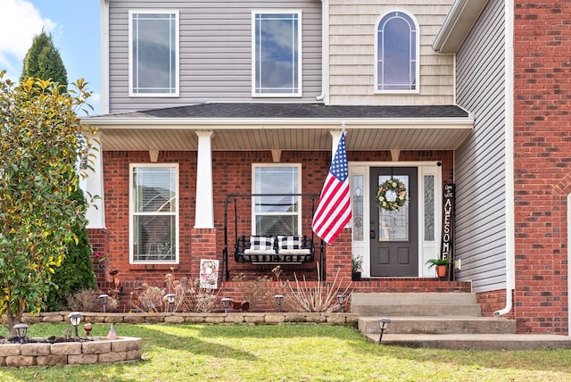 view of exterior entry with brick siding