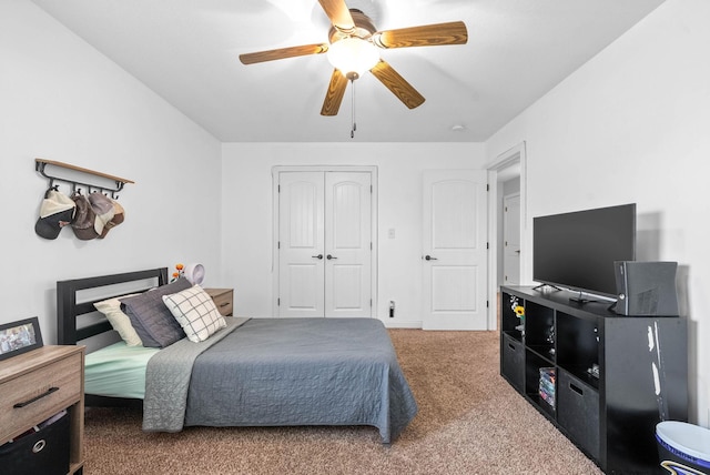 carpeted bedroom with a closet and a ceiling fan